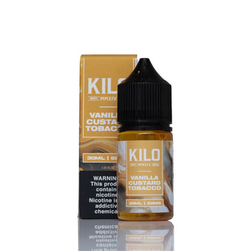 A 30ml bottle of Kilo Vanilla Custard Tobacco e-liquid with its matching cardboard packaging box, displayed on a reflective white surface against a white background.