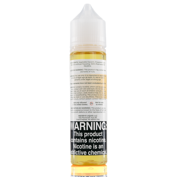 A mister e-liquid bottle is placed on a reflective surface and against a white background. The bottle outlines the ingredients and the warning label. 
